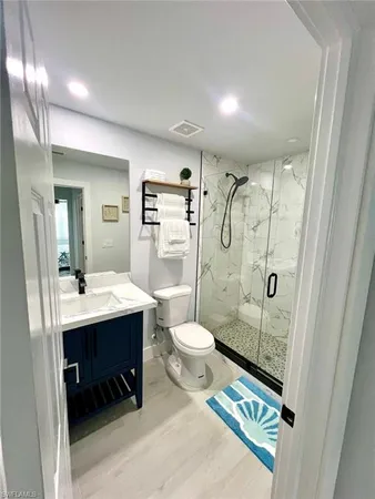 a bathroom with a sink toilet and mirror