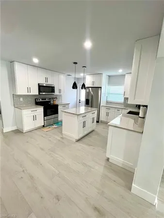 a kitchen with a sink cabinets and window
