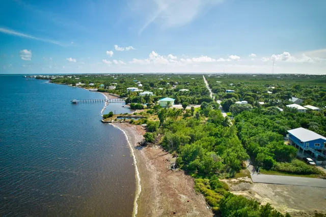 an aerial view of a houses with yard