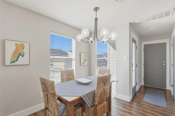 a view of a dining room with furniture wooden floor and chandelier