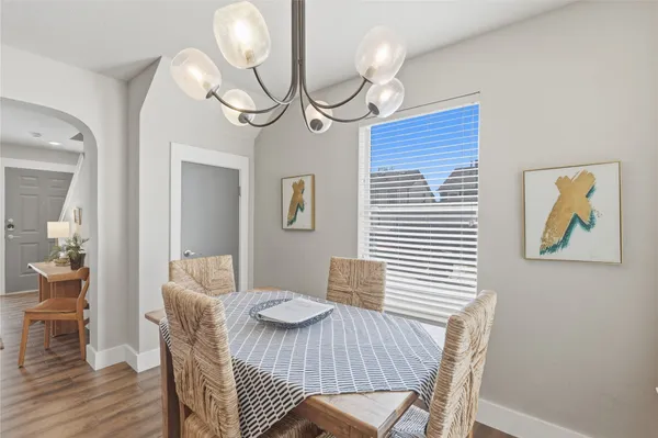 a view of a dining room with furniture wooden floor and chandelier