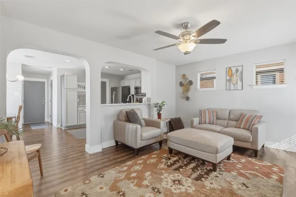 a living room with furniture and a wooden floor