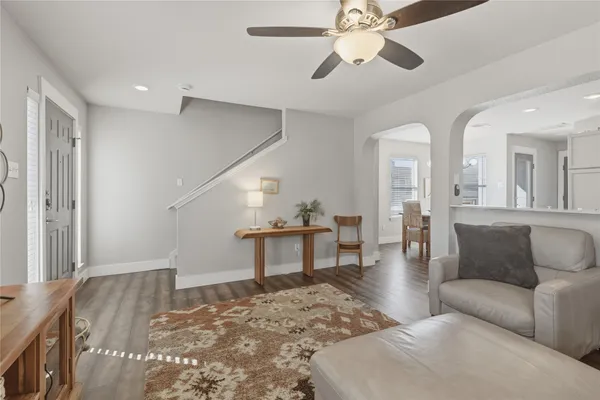 a living room with furniture and a dining table