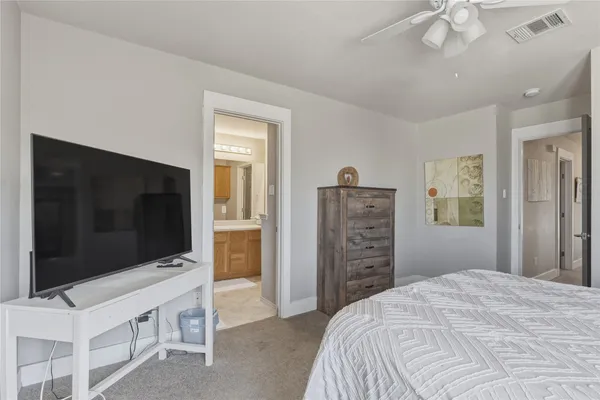 a bedroom with a flat screen television and a bed