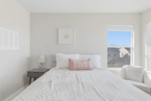 a bedroom with a bed and a painting