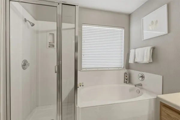 a white bath tub sitting next to a white sink