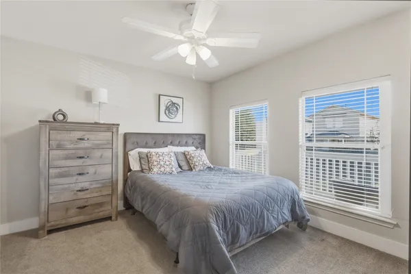 a spacious bedroom with a bed a window and closet