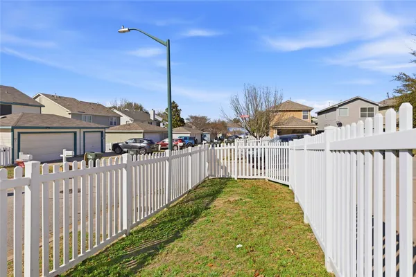 a view of a house with wooden fence