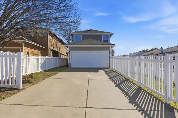 a front view of a house with wooden fence