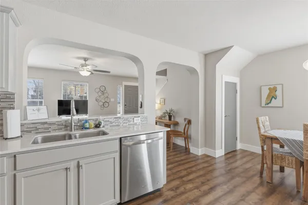 a hall with cabinets and wooden floor