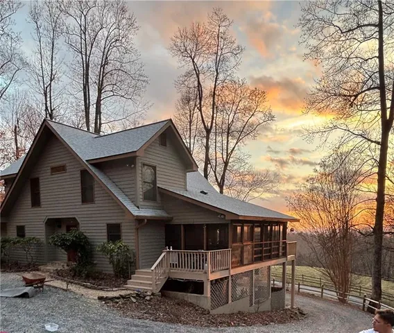 a view of a house with a yard and trees