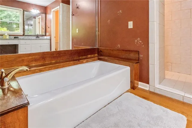 a spacious bathroom with a tub and shower