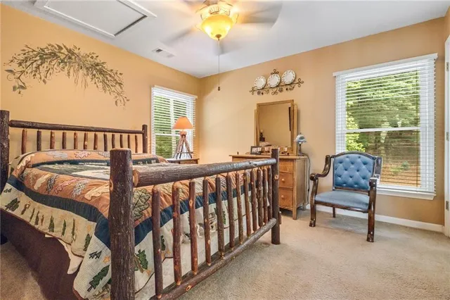 a view of a bedroom with furniture and a window