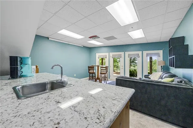a kitchen with sink refrigerator and large window