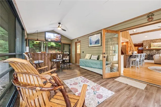 a dining room with furniture water view and wooden floor