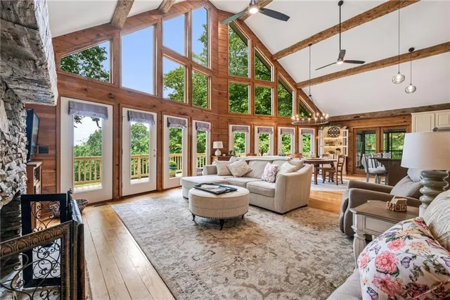 a living room with fireplace furniture and a floor to ceiling window