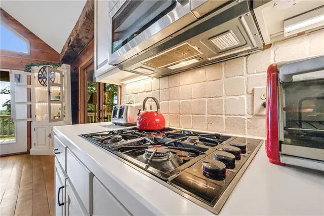 a stove top oven sitting inside of a kitchen