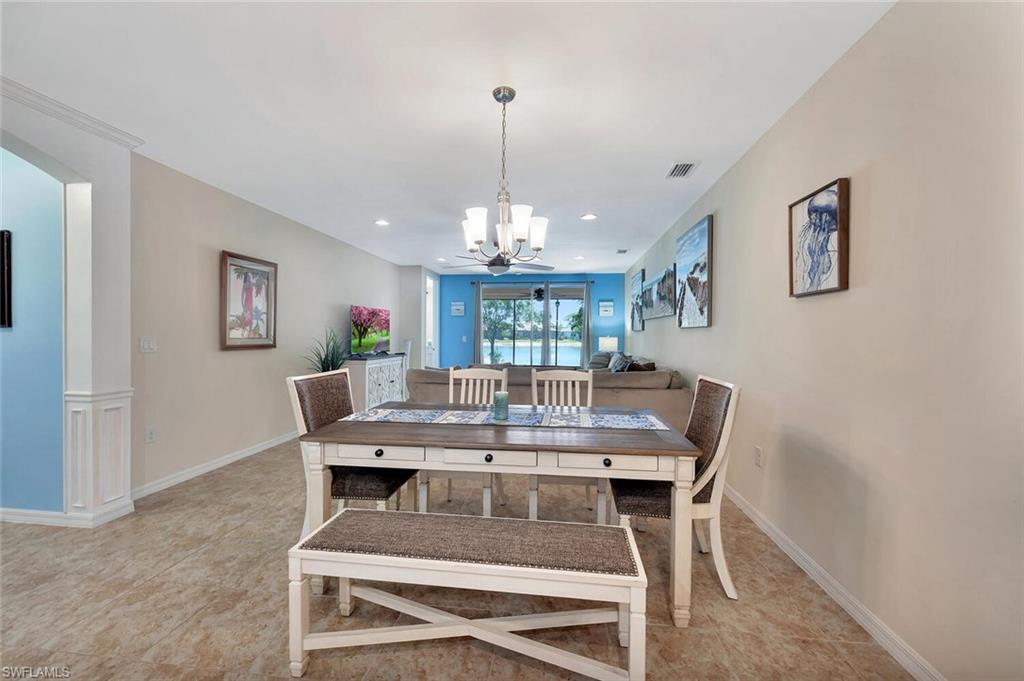 14940 Edgewater Circle Naples, FL 34114 - Photo 14 of 39 a view of a dining room with furniture window and wooden floor