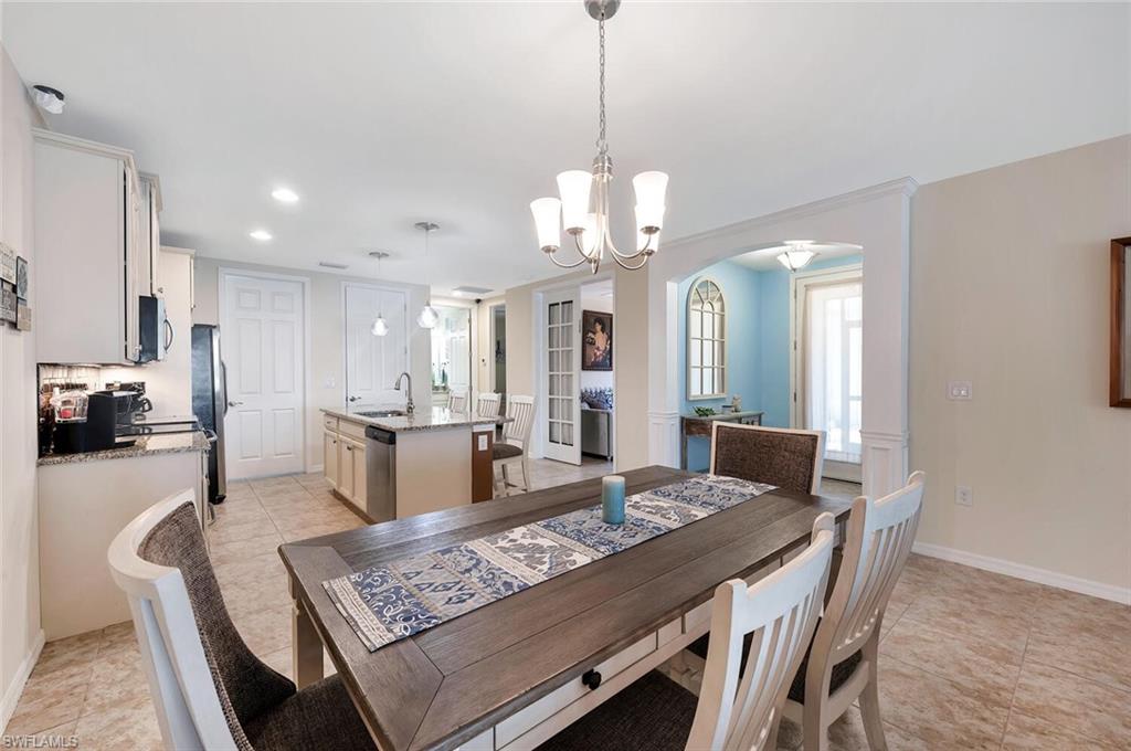 14940 Edgewater Circle Naples, FL 34114 - Photo 15 of 39 a view of a dining room with furniture