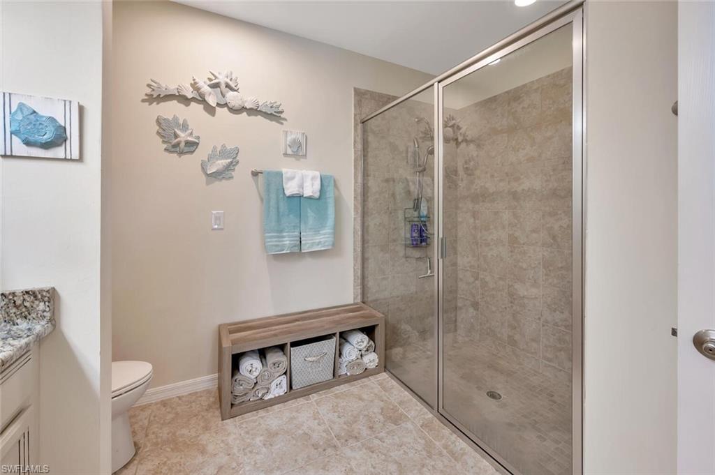 14940 Edgewater Circle Naples, FL 34114 - Photo 20 of 39 a bathroom with a shower toilet and sink