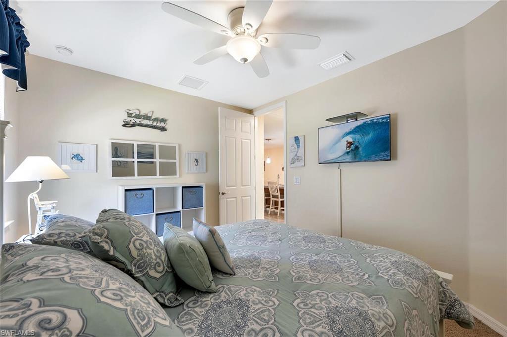 14940 Edgewater Circle Naples, FL 34114 - Photo 22 of 39 a bedroom with a bed workspace and a window