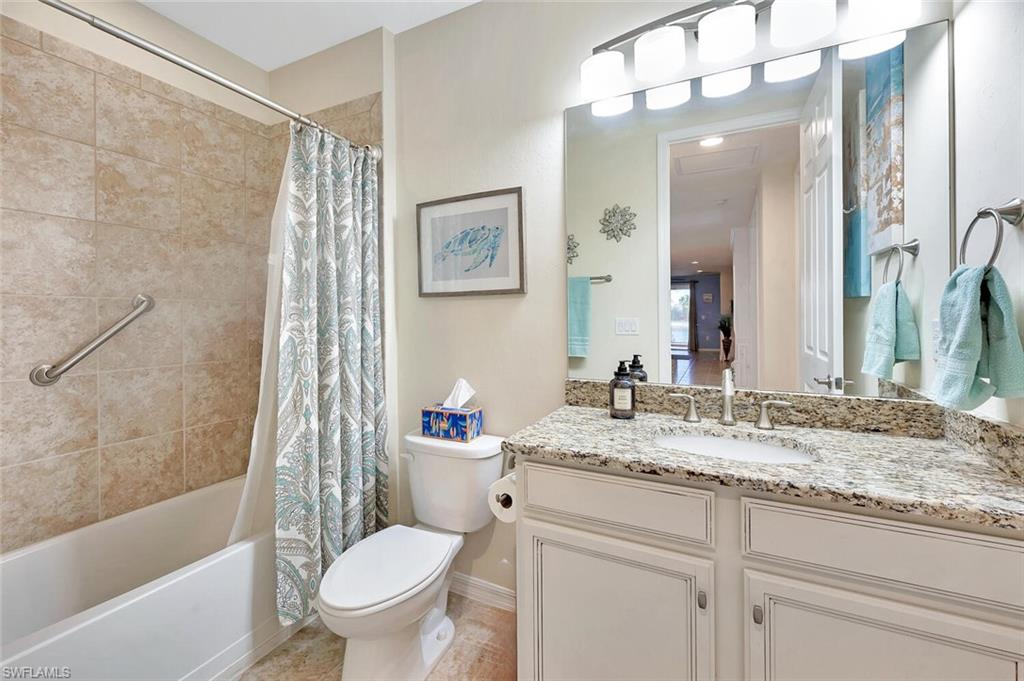 14940 Edgewater Circle Naples, FL 34114 - Photo 23 of 39 a bathroom with a granite countertop sink toilet and shower
