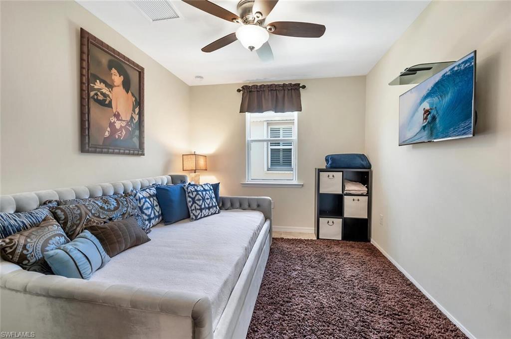14940 Edgewater Circle Naples, FL 34114 - Photo 24 of 39 a living room with furniture and a rug