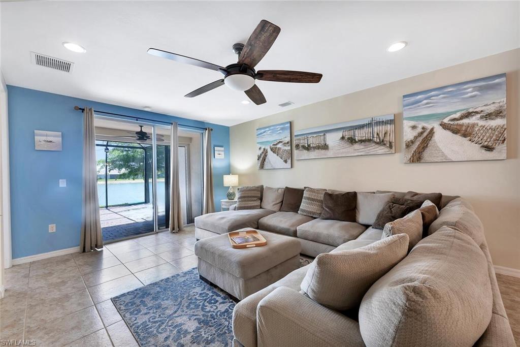 14940 Edgewater Circle Naples, FL 34114 - Photo 6 of 39 a living room with furniture and a large window