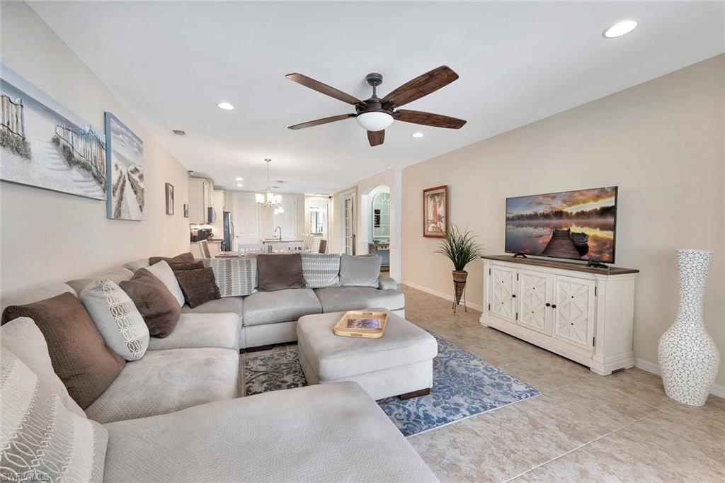 14940 Edgewater Circle Naples, FL 34114 - Photo 7 of 39 a living room with furniture kitchen view and a window