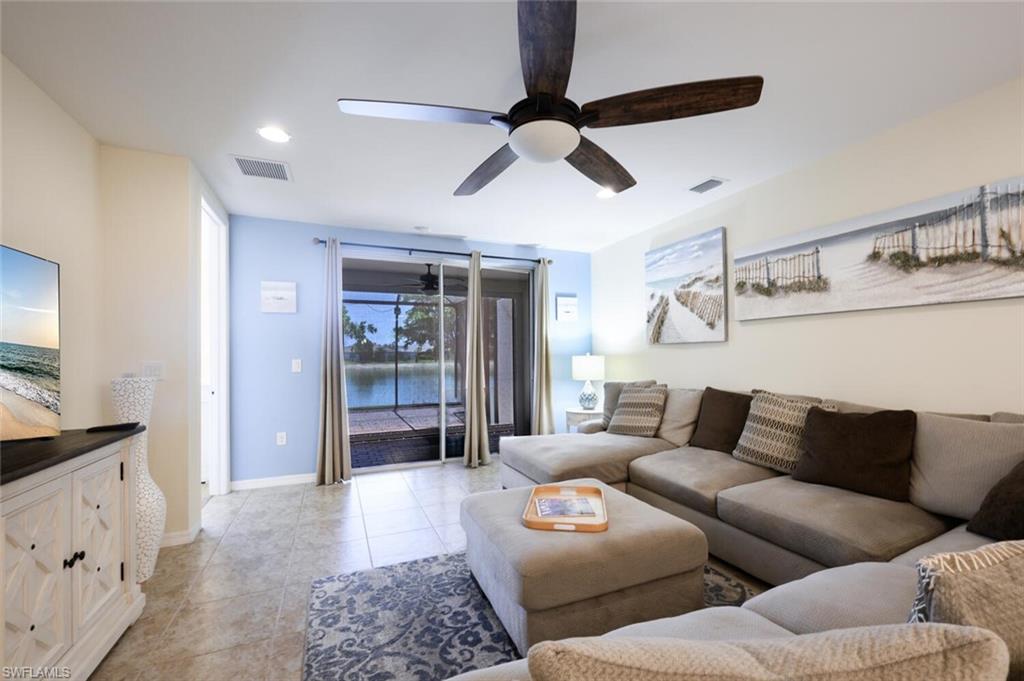 14940 Edgewater Circle Naples, FL 34114 - Photo 10 of 39 a living room with furniture and a walk in closet