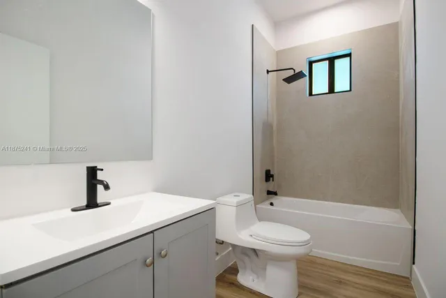 a bathroom with a toilet a sink and mirror