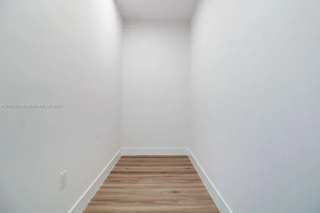 a view of hallway with wooden floor