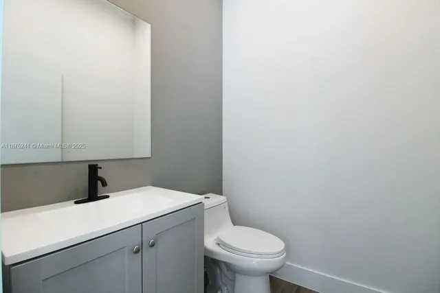 a bathroom with a sink toilet and vanity