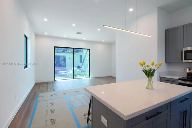 a view of kitchen with granite countertop window
