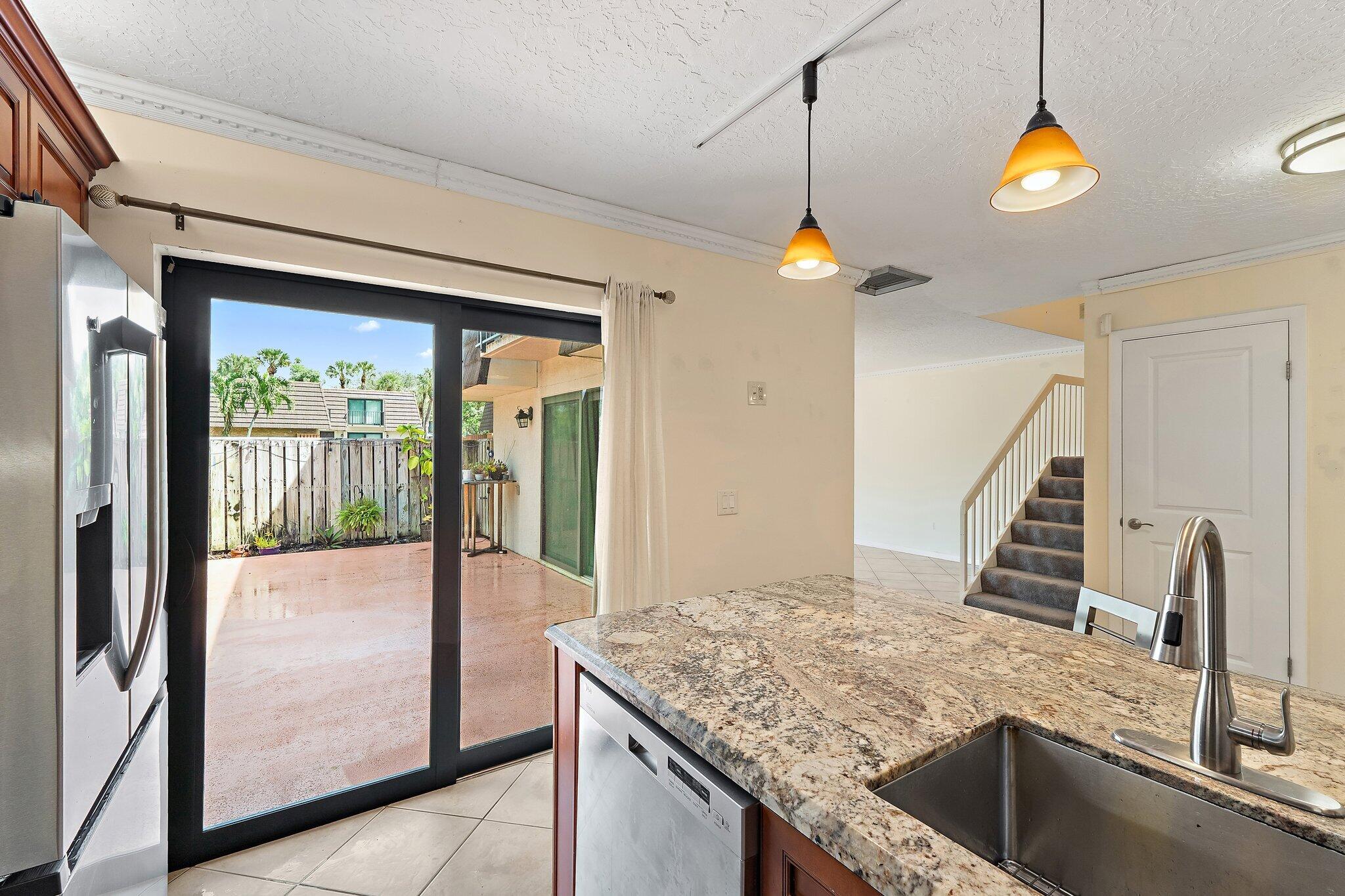 1514 15th Court Jupiter, FL 33477 - Photo 12 of 25 a kitchen view of a kitchen island a stove and a sink