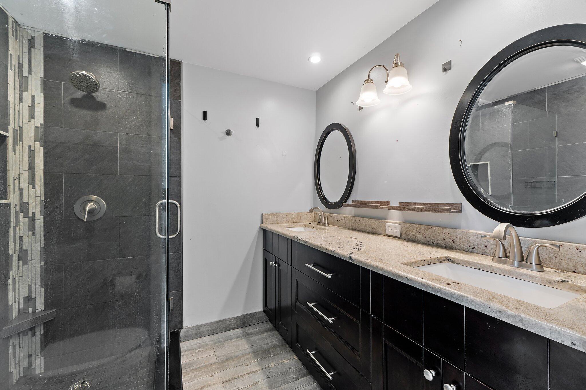 1514 15th Court Jupiter, FL 33477 - Photo 17 of 25 a bathroom with a double vanity sink mirror and shower