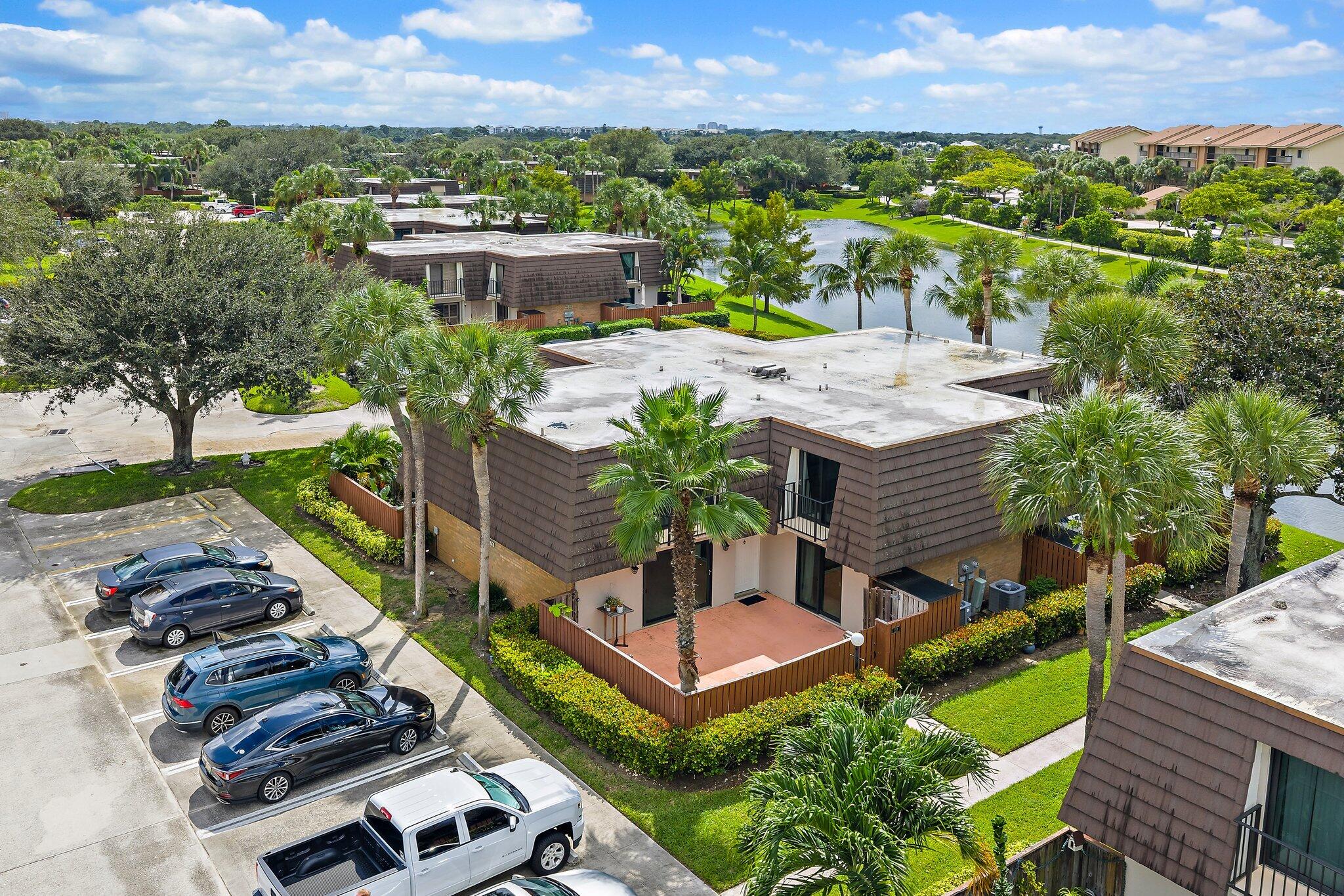 1514 15th Court Jupiter, FL 33477 - Photo 2 of 25 an aerial view of multiple houses with a yard