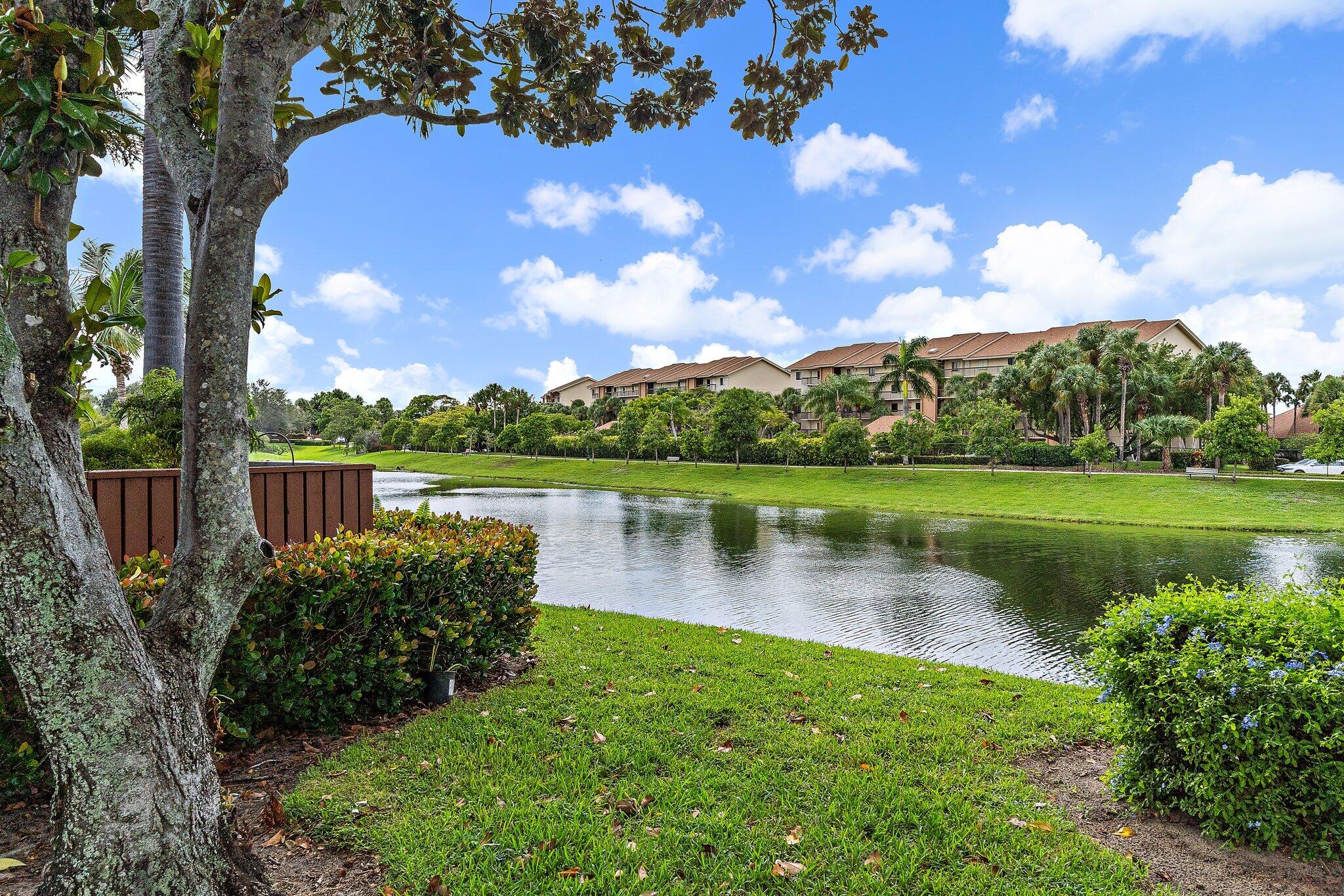 1514 15th Court Jupiter, FL 33477 - Photo 23 of 25 a view of a lake with a house in the background