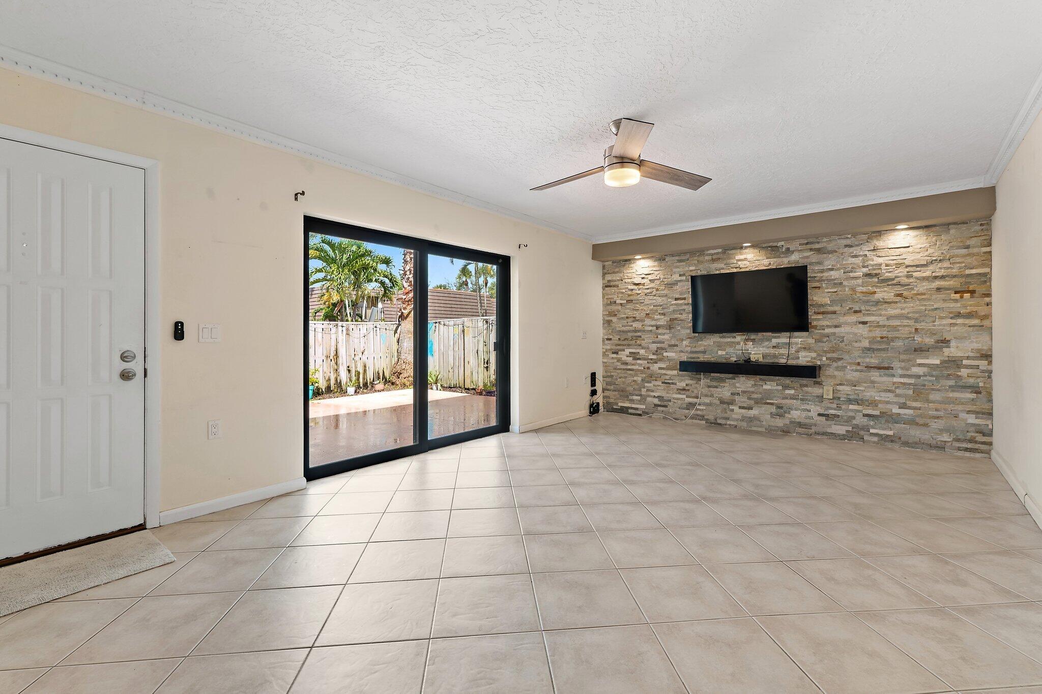 1514 15th Court Jupiter, FL 33477 - Photo 9 of 25 a view of an empty room with a flat screen tv
