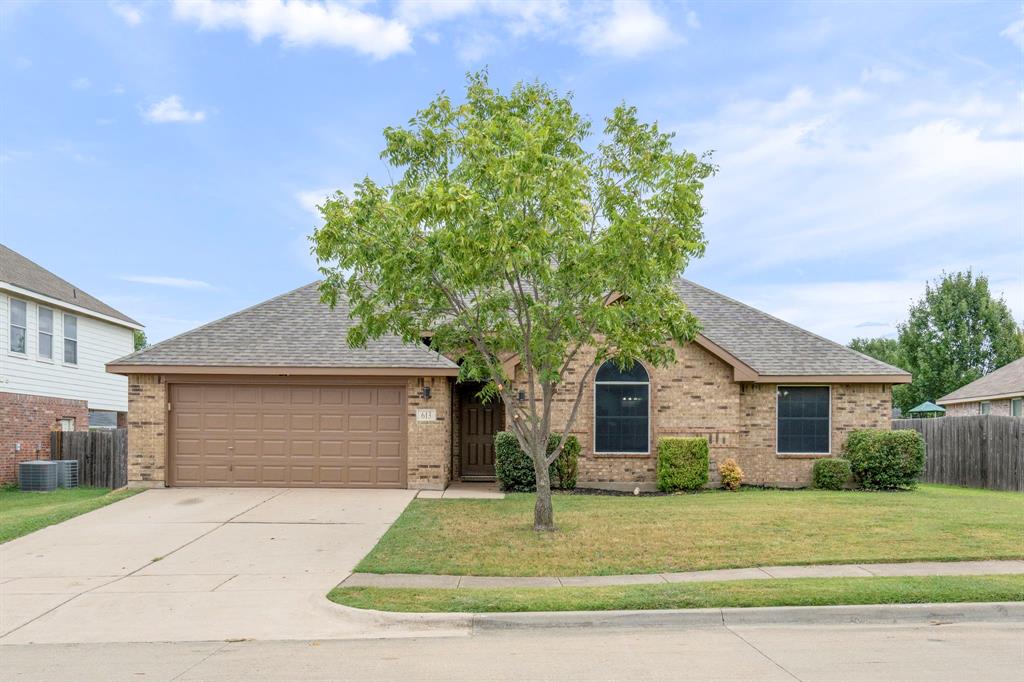 613 Hummingbird Trail Crowley, TX 76036 - Photo 1 of 37 a front view of a house with a yard and garage