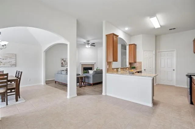 a kitchen with stainless steel appliances granite countertop a sink stove and cabinets