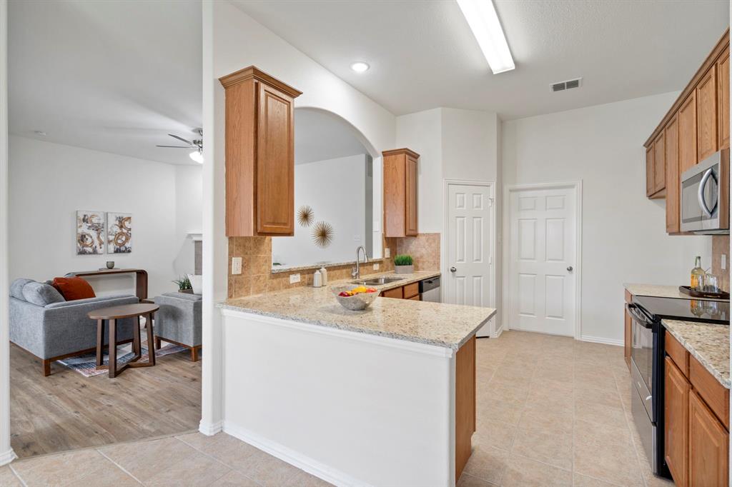 613 Hummingbird Trail Crowley, TX 76036 - Photo 13 of 37 a spacious bathroom with a double vanity sink a mirror and a bathtub