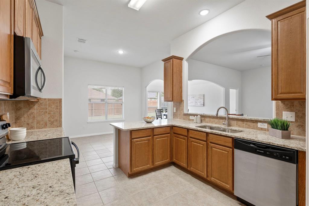 613 Hummingbird Trail Crowley, TX 76036 - Photo 14 of 37 a kitchen with a sink and cabinets