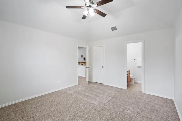 a bathroom with a granite countertop sink a toilet and a mirror