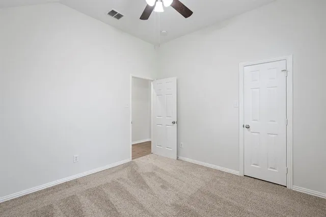 a bathroom with a granite countertop toilet sink and mirror