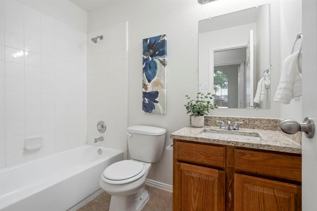 613 Hummingbird Trail Crowley, TX 76036 - Photo 28 of 37 a bathroom with a granite countertop toilet sink and mirror