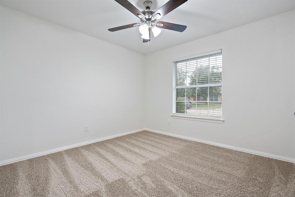 613 Hummingbird Trail Crowley, TX 76036 - Photo 29 of 37 an empty room with a window and a fan