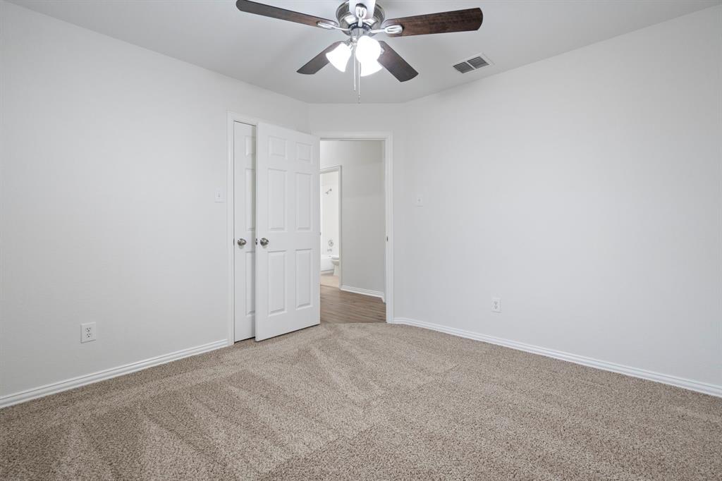 613 Hummingbird Trail Crowley, TX 76036 - Photo 30 of 37 an empty room with closet and a chandelier fan