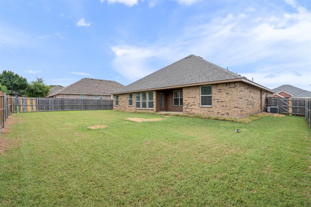 613 Hummingbird Trail Crowley, TX 76036 - Photo 34 of 37 a front view of a house with garden