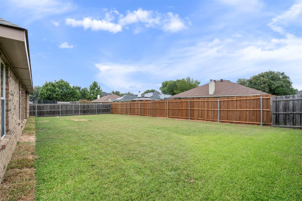 613 Hummingbird Trail Crowley, TX 76036 - Photo 36 of 37 a view of a backyard with a garden
